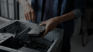 IT technician installing hard drive during technology infrastructure upgrade for business transformation
